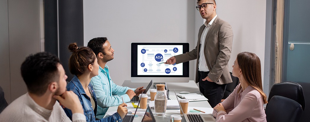Small team attending a website accessibility training session, reviewing ADA and WCAG concepts during a collaborative presentation